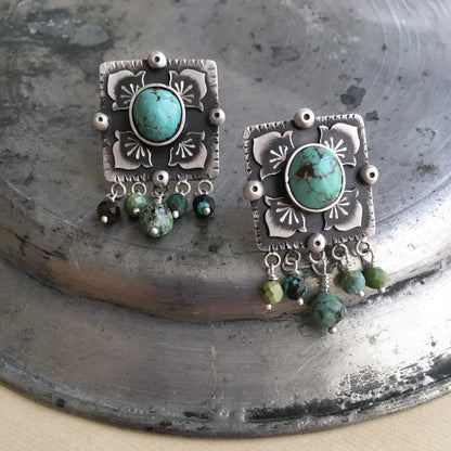 handcrafted oxidized silver stud earrings decorated with turquoise gemstones and floral motifs